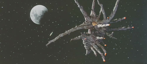 The Adventures of Buckaroo Banzai Across the 8th Dimension: A ship from Planet 10 carrying Black Lectroids approaches Earth. One of my favorite things about this movie is the unorthodox, organic ship designs.