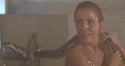 Blade Runner: Zhora's sceptical attention to Deckard's story. (It's nice to see a woman that is apparently comfortable handling snakes.)