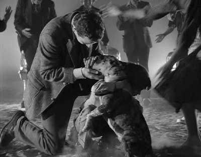 Frankenweenie: Dad and Victor hug the twice revived dog Sparky while the ecstatic neighbors cheer.