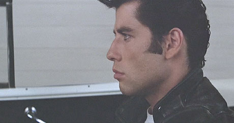 Grease: Danny drives for the injured Kenickie.