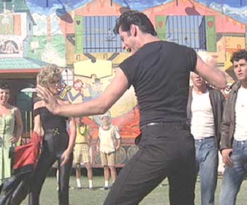 Grease: Danny responds with enthusiasm to Sandy's tranformation.