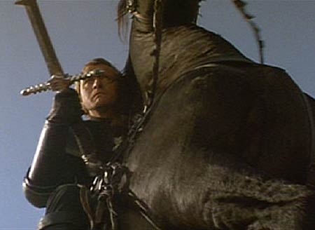 Ladyhawke: Navarre clutches his sword from the back of his rearing horse and prepares to do battle.