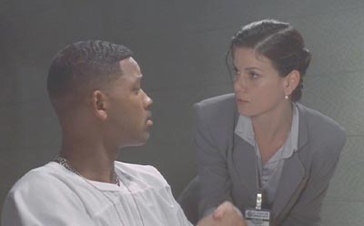 Men in Black: Dr. Laurel Weaver tries to communicate her suspicions to Officer Edwards.