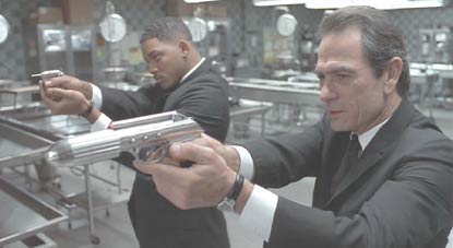 Men in Black: J and K looking for a clear shot at Edgar.