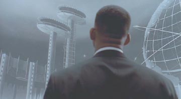Men in Black: J gets an idea from the World's Fair mural at MIB Headquarters.