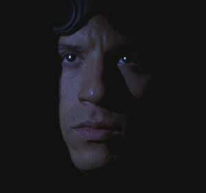 Pitch Black: Riddick pulls back into the darkness to avoid one of the aliens.