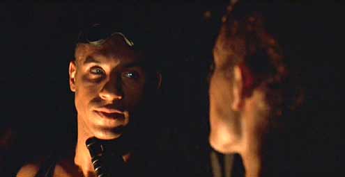 Pitch Black: Riddick faces off with Johns. This is an example of how director Twohy uses light to carve out his subjects in Pitch Black. Awesome.