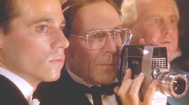 Strictly Ballroom: Scott Hastings, his father, Doug Hastings (Barry Otto) and dance instructor Les Kendell (Peter Whitford) look on as Fran dances. Not for the first time, Doug films her.