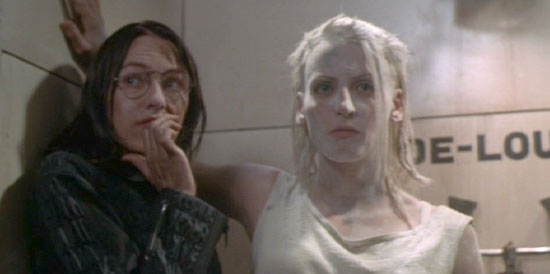 Tank Girl: Rebecca gets between Jet and the Water & Power soldier that's been hassling her.