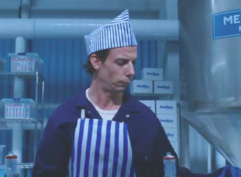 Charlie and the Chocolate Factory: Mr. Bucket (Noah Taylor) working in the toothpaste factory.
