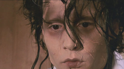 Edward Scissorhands: Edward's face is scarred from his own touch.