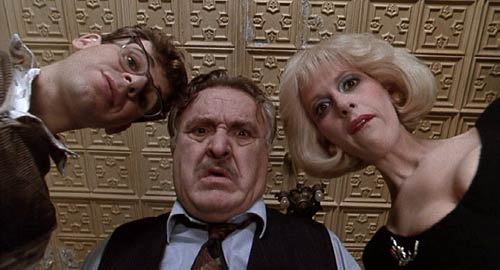 Little Shop of Horrors (1986): Seymour (Rick Moranis), Mr. Mushnik (Vincent Gardenia) and Audrey (Ellen Greene) peer at Seymour's strange and unusual plant.