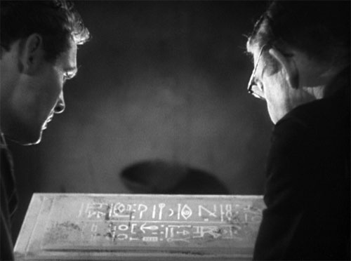 The Mummy (1932): British archaeologists Sir Joseph Whemple (Arthur Byron) and 
Ralph Norton (Bramwell Fletcher) read the curse that awaits any who disturb the grave of Im-ho-tep.



