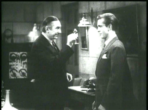 The Devil Bat: Carruthers' first victim, Roy Heath (John Ellis), innocently accepting the shaving lotion of death.